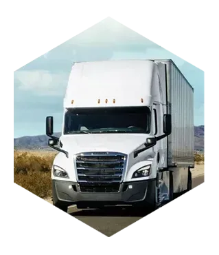 White tractor trailer driving on a desert road